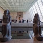 This photograph shows two statues (frontal view) of Amenhotep III at the Temple of Dendur in the Metropolitan Museum of Art in New York.