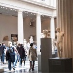 This photograph shows a large gallery enclosed by a colonnade filled with stone sculptures from ancient Rome and Greece.