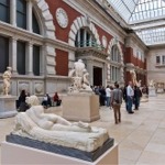 This photograph shows people in European Sculpture Court at the Metropolitan Museum of Art in New York City.