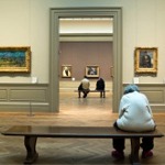 This photograph shows people sitting in one of the European painting galleries at the Metropolitan Museum of Art in New York City.