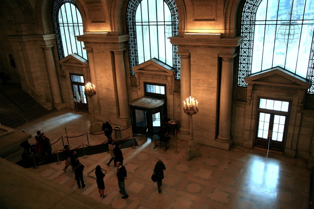 New York Public Library main branch's Astor Hall. The image also shows the elaborate Beaux-Arts features used in the library's design and construction.