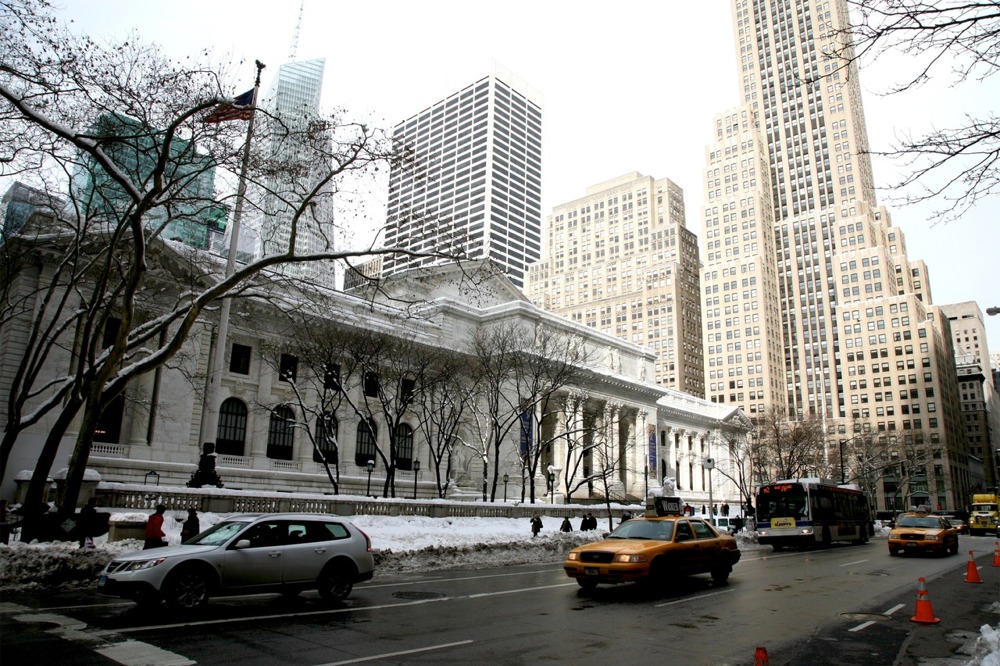 The New York Public Library main branch facade along Fifth Avenue at its intersection with East 41st Street during day time in winter.