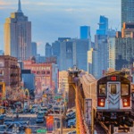 7 Line Subway Train in Queens with the Manhattan Skyline.